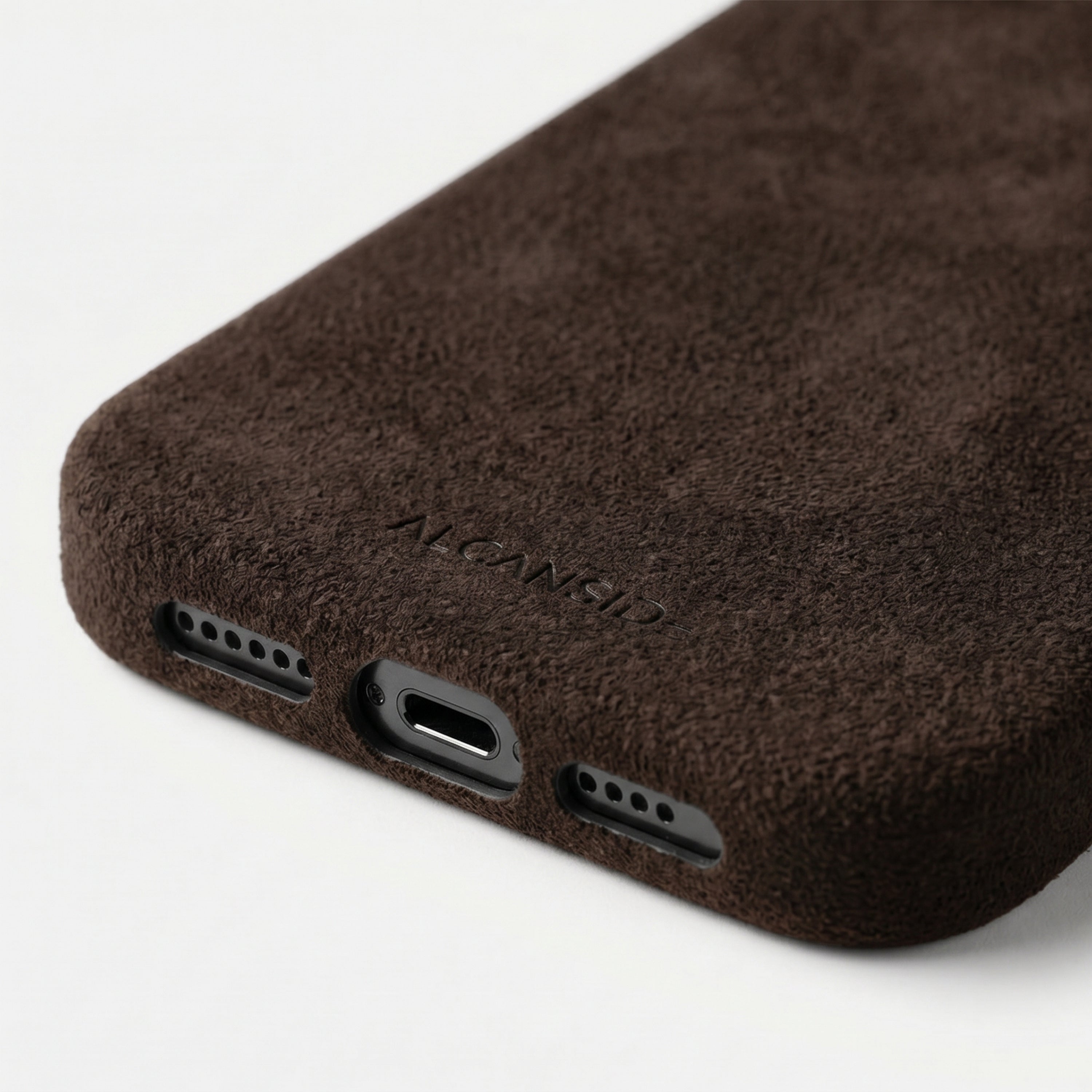 iPhone 16e Chocolate Brown Alcantara® Case – bottom detail with ALCANSIDE emboss